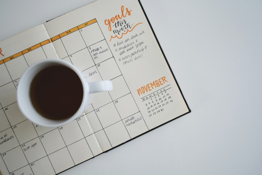 Calendar and coffee cup representing scheduling, planning, and productivity